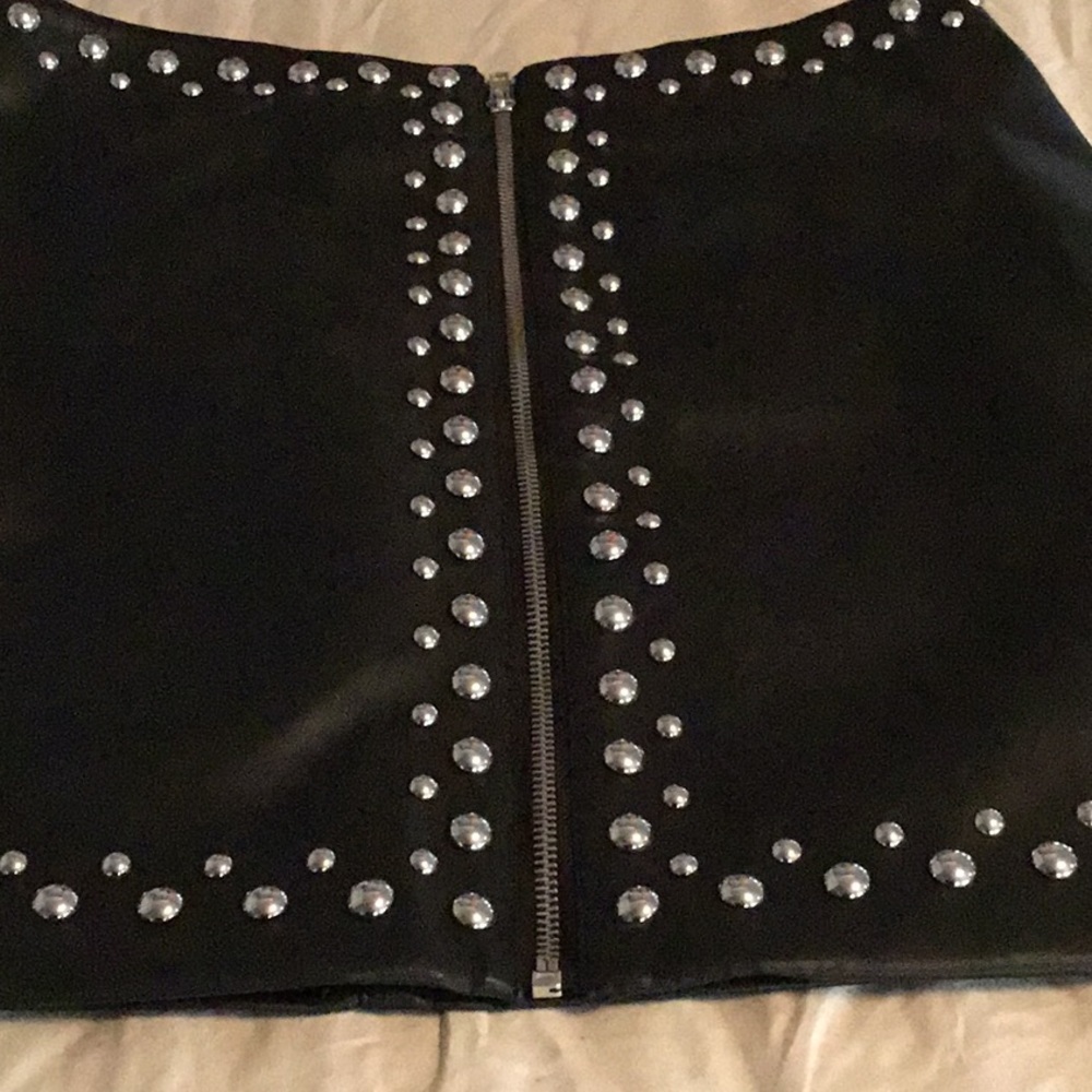 Black leather. Studded with zipper